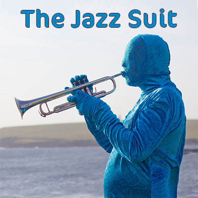 man wearing an all over blue suit playing the trumpet